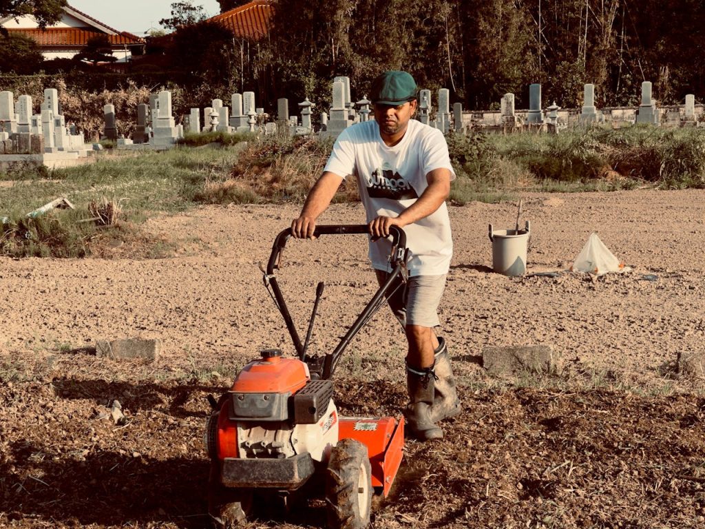 man-using-lawn-mower-in-rural-cemetery-setting-29413845 man-using-lawn-mower-in-rural-cemetery-setting-29413845